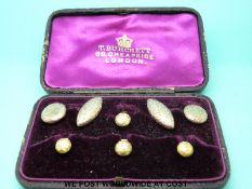 A yellow metal stud and cufflink set marked 10ct in original fitted box.