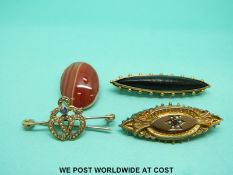 An Edwardian brooch in the form of two hearts set with seed pearls and a sapphire,