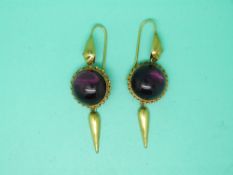 A pair of Victorian yellow metal earrings set with a large amethyst cabochon to each