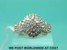A 9ct gold ring set with diamonds in a cluster (size P)