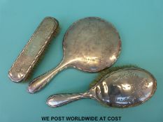 A hallmarked silver three-piece dressing table set