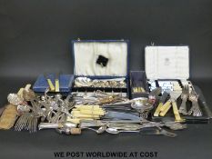 A large quantity of boxed and loose cutlery, including hallmarked silver handled,