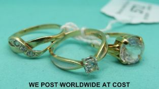 A yellow metal ring set with paste and two 9ct gold rings set with cubic zirconia