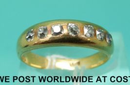 An 18ct gold ring set with seven old cut diamonds (size Q)