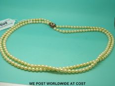 A two strand pearl necklace the 9ct gold clasp set with seed pearls and rubies