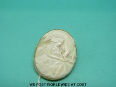 A 9ct gold brooch set with an oval cameo depicting a woman and bird