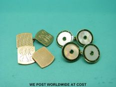 A pair of 9ct gold cufflinks set with mother of pearl surrounded by green enamel with green stones