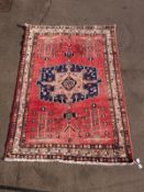 A wine ground Turkoman rug with central blue and pink gul (L228xW159cm)