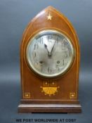 An Edwardian mitre cased mantel clock with inlaid boxwood and mother of pearl decoration,