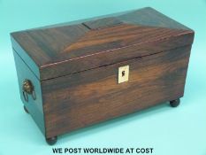 A rosewood or similar exotic wood tea caddy with two divisions flanking a mixing bowl
