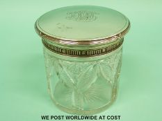 A Fabergé silver topped dressing table pot with ribbon decoration and banding around the top and