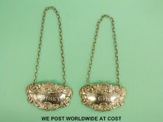 A pair of hallmarked silver whisky and gin bottle tickets