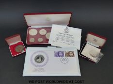 A Commonwealth of the Bahamas sterling silver coin set together with a St Helena crown,
