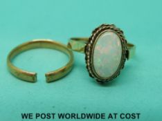 A 9ct gold ring set with an opal and a yellow metal band