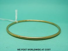 A 9ct gold bangle (12.