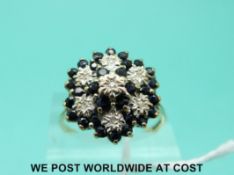 A 9ct gold ring set with sapphires and diamonds in a large cluster (size U)