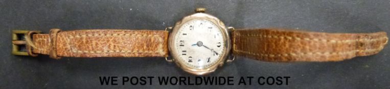A 9ct gold ladies wristwatch, on brown leather strap.