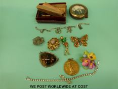 A collection of costume jewellery to include a silver and tigers eye brooch, silver charm bracelet,
