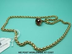 A yellow metal necklace with a citrine fob (88.