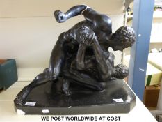 A large plaster statue of two classical wrestlers,