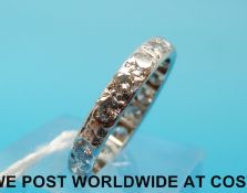 A white metal ring set with 17 diamonds each measuring approximately 0.