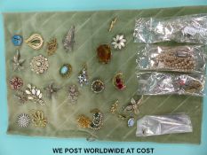 A collection of costume jewellery to include silver brooches,