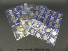 Sixty collectable £2 coins in collector's pockets, includes WW1, Magna Carta, Underground,