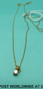 A 9ct gold pendant set with a diamond on 9ct gold chain