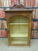 A 19thC glazed hanging cabinet with carved pediment (H96 x W63 x D30cm)