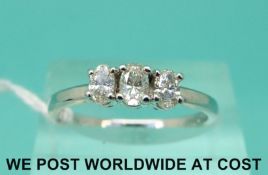 An 18ct white gold ring set with three oval cut diamonds totalling approximately 0.