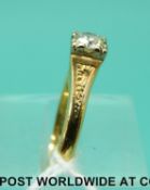 An 18ct gold ring set with a diamond of approximately 0.