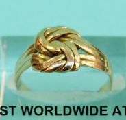 A yellow metal ring in the form of a knot marked 18ct (Size M, 2.