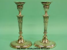 A pair of Edward VII hallmarked silver candlesticks with reeded decoration,