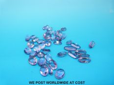 A packet of loose oval cut amethysts