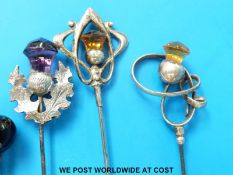 Three silver topped hat pins in the form of thistles set with amethysts and citrine together with