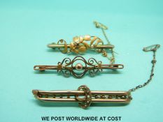 Two 9ct gold brooches set with seed pearls and a yellow metal brooch (7.