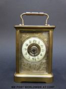 A late 18th/early 20thC brass cased carriage clock with ivory coloured enamel chapter ring,