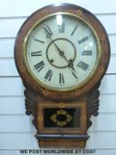 A mid to late 19thC drop dial wall clock with original labels for Waterbury Clock Company, New York,