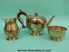 A hallmarked silver three piece tea set, height of teapot 16.