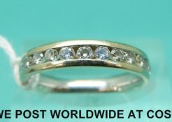 An 18ct gold half eternity ring set with eleven diamonds (size M)