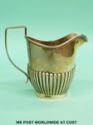 A George V hallmarked silver cream jug with reeded decoration, Birmingham 1938, height 9cm,