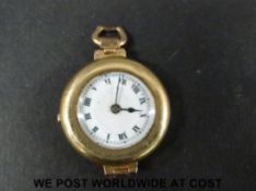 A 9ct gold ladies wristwatch with black Roman numerals on white enamel dial.