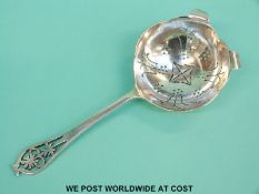 A hallmarked silver tea strainer with period decoration, Sheffield 1958, length 15cm,