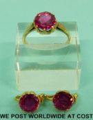 A yellow metal ring set with a round cut synthetic diamond with matching earrings