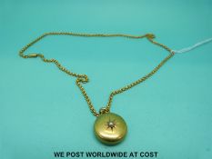 A Victorian locket marked 15ct set with a pearl on a yellow metal chain marked 15ct (9.