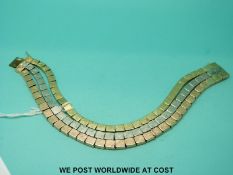 A tri-coloured gold bracelet marked 585, made up of three strands of square links (36.