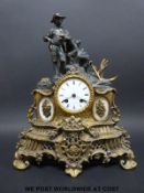 A brass figural French mantel clock with two train movement striking on a bell,