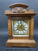 An oak cased mantel clock with three train Wurttemberg movement chiming on the quarter hour,