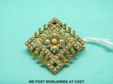 A 15ct gold Edwardian brooch and pendant set with seed pearls and peridot in a floral design