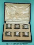 A cased set of six Mappin & Webb hallmarked silver napkin rings and a further single silver napkin